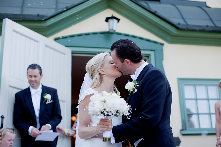 groom kissing bride at wedding